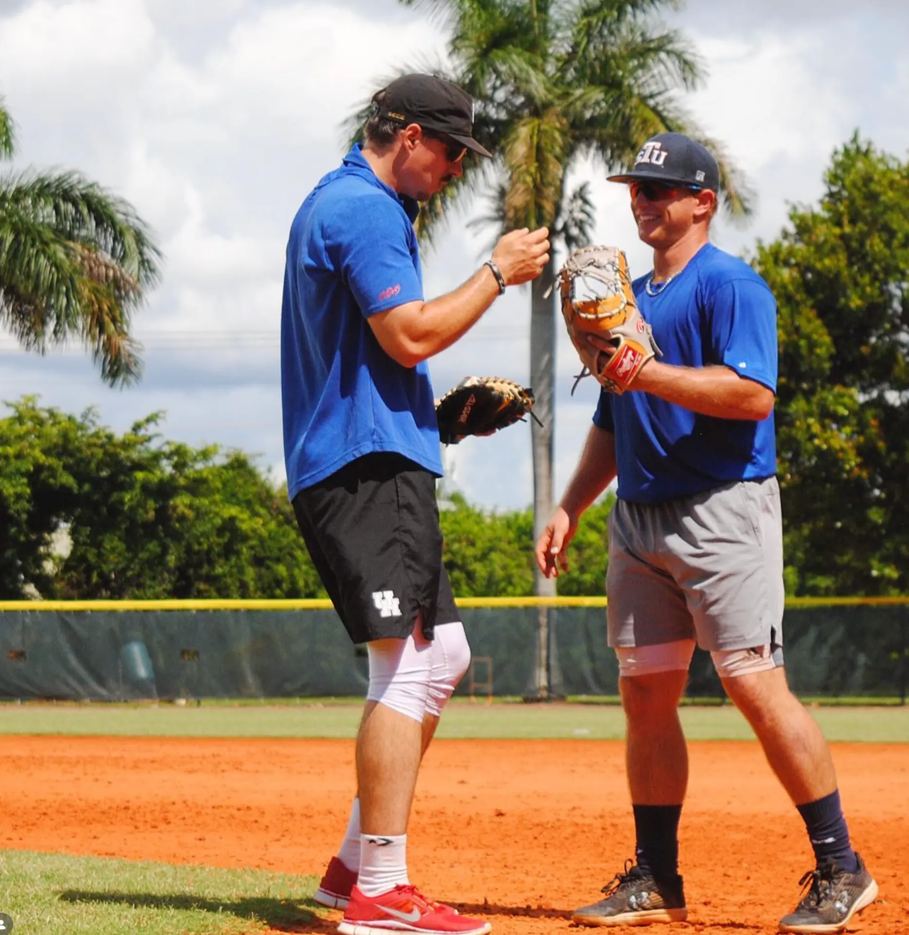 Justin Sizemore talking with a player on the field