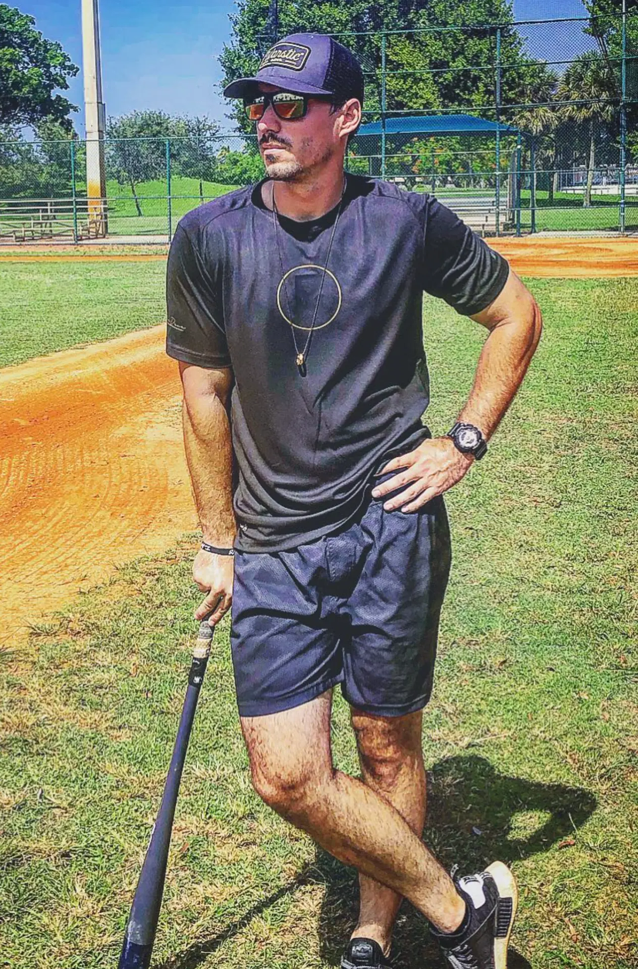 Justin Sizemore on the field with a bat during a training session