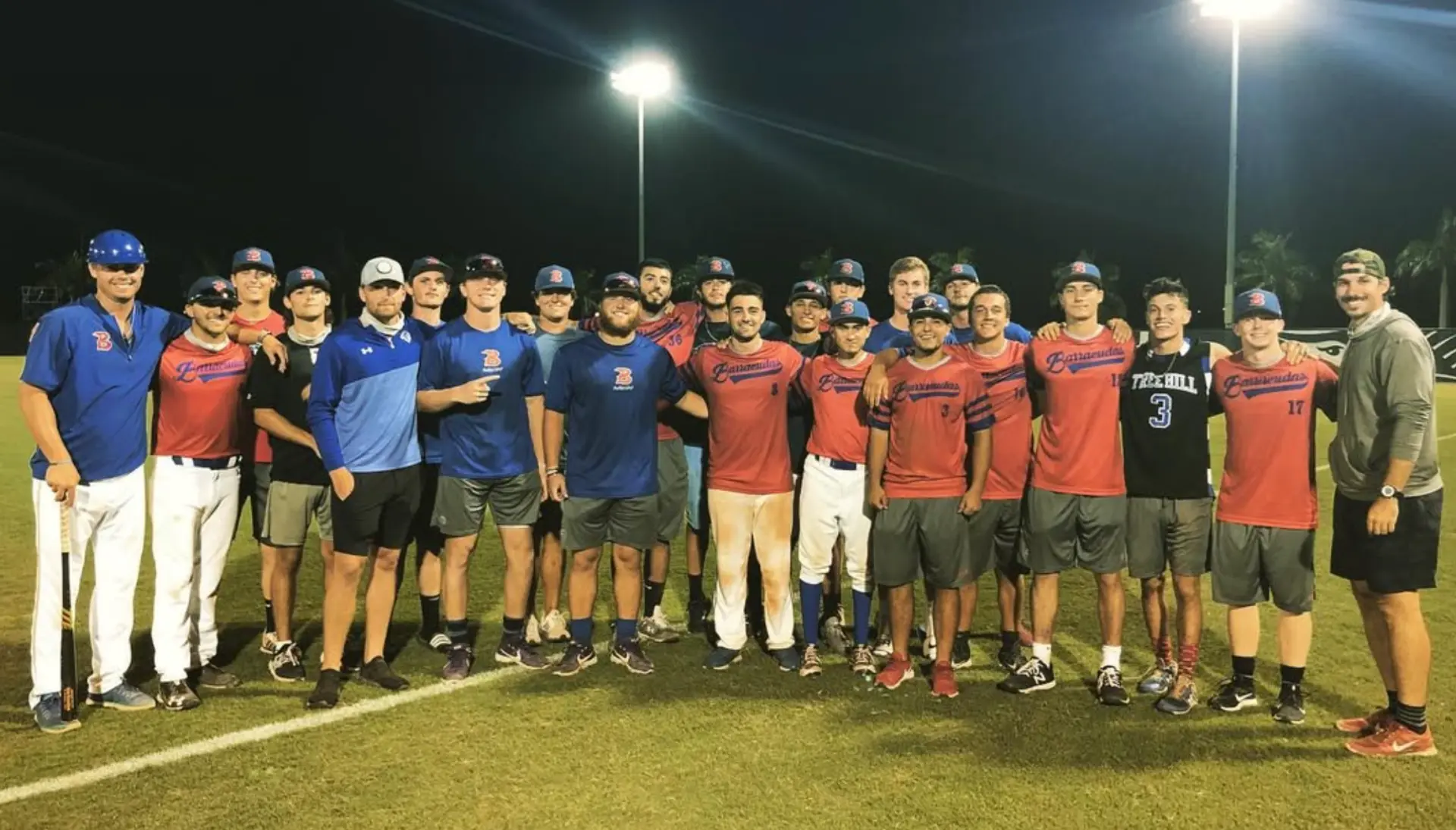 Team photo under the lights with the Barracudas