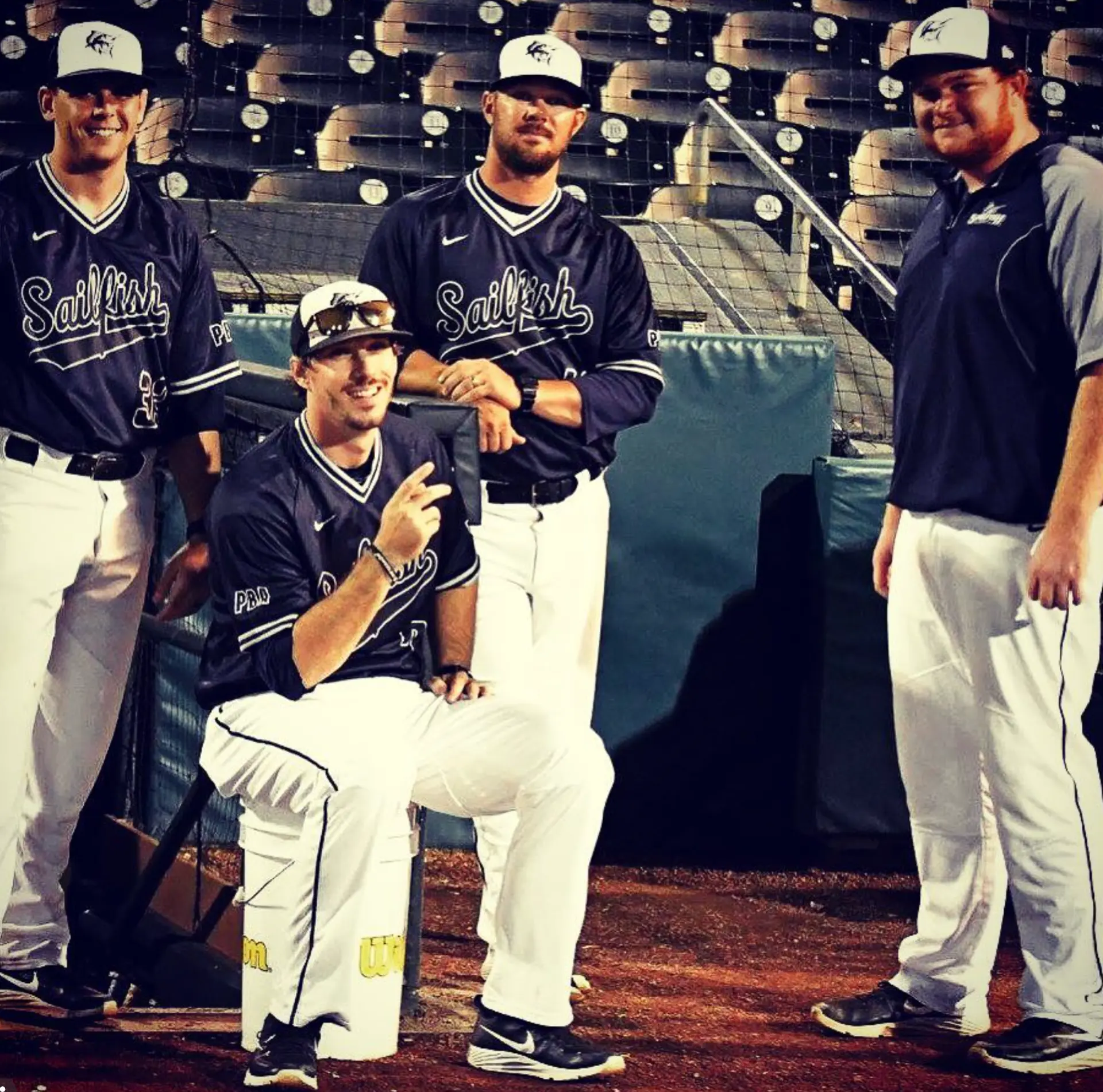 Palm Beach Atlantic Sailfish players in the dugout