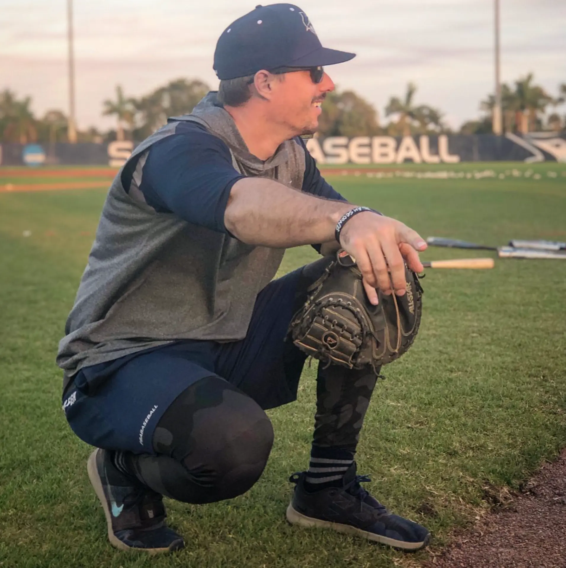 Justin Sizemore in catcher's gear on the field at dusk